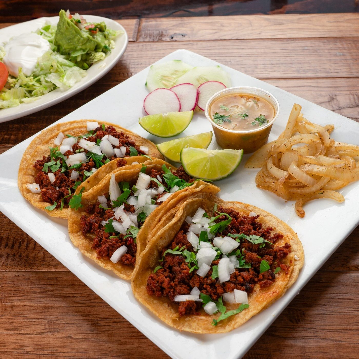 El Vaquero tacos topped with onion and cilantro