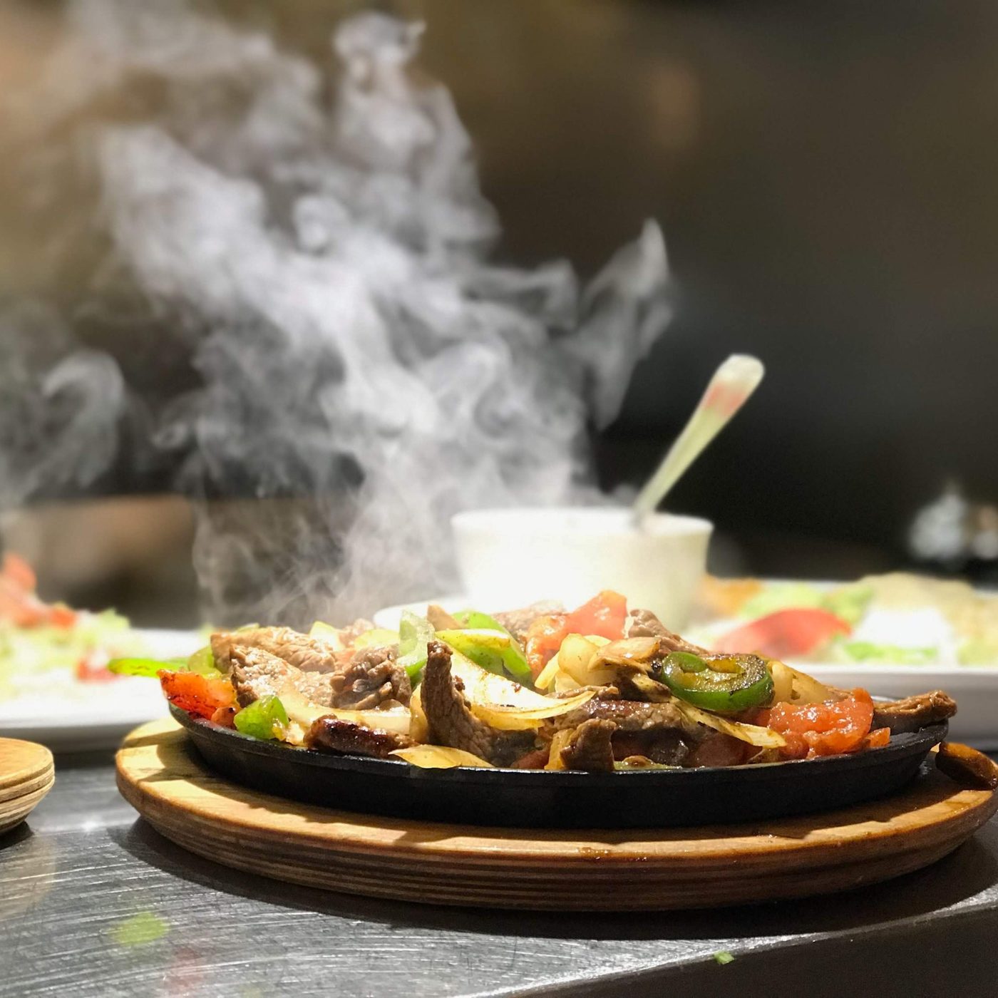 Sizzling El Vaquero fajitas with peppers and onions